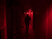 Jason Greeley-Roberts, owner of the Clark County Scaregrounds Haunted House Scream Park, walks through an access corridor behind one of his haunts while checking on the actors on Thursday night, Oct. 25, 2018.