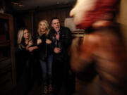 Actors Billie Lourd, left, Leslie Grossman, middle, and Colton Haynes, right, members of the cast of FX’s “American Horror Story” get spooked Sept. 22, 2017, while going through a Halloween-themed maze at Universal Studios.