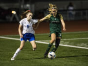 Mountain View’s midfielder Taylor Armstrong competes with Evergreen’s Leiah Keniston at McKenzie Stadium.