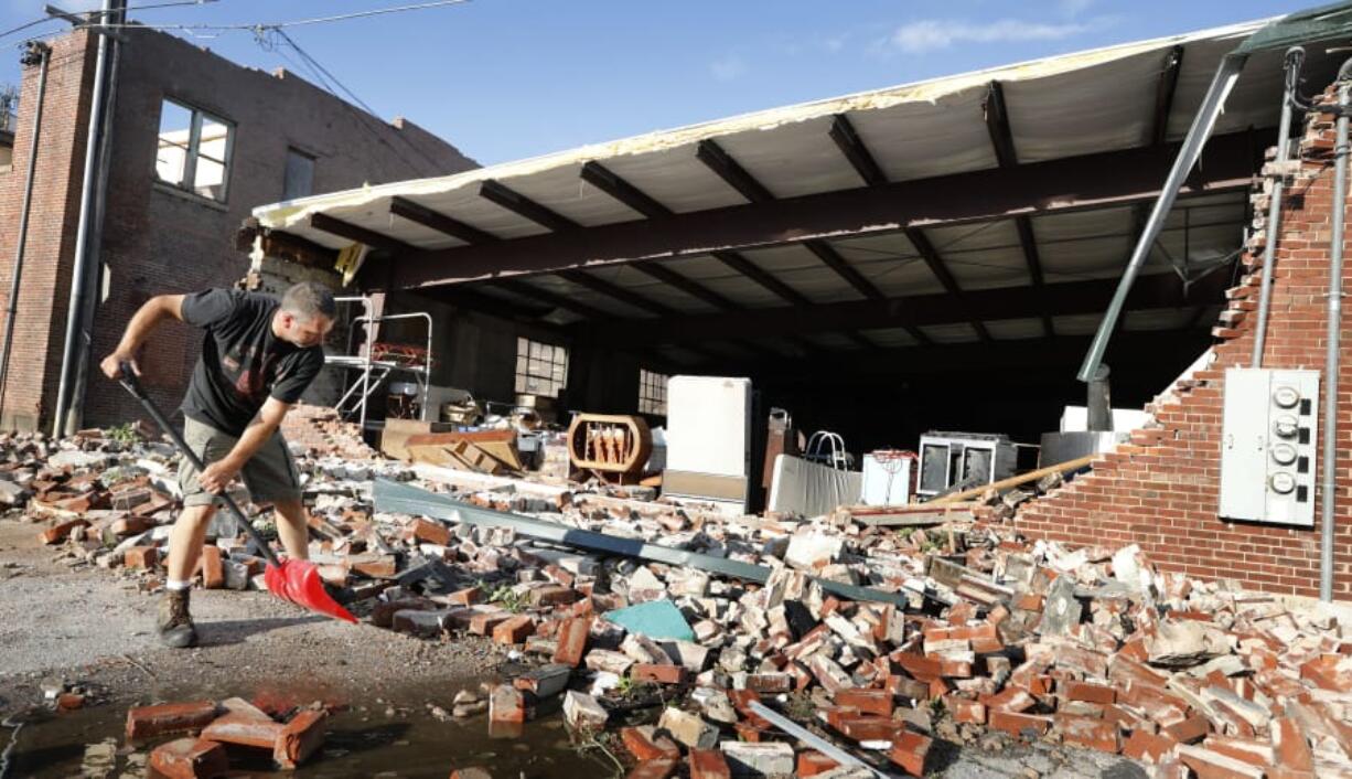 Roy Schweinebart of Marshalltown, Iowa, shovels bricks from a tornado-damaged building July 19 in Marshalltown, Iowa. Several buildings were damaged by a tornado in the main business district in town including the historic courthouse.