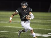 Woodland's Tyler Flanagan runs the ball against Ridgefield during a game at Woodland High School on Friday night, OCt. 12, 2018..