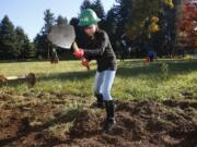 Volunteer Hong Nguyen removes sod for an all-season pathway at Raymond E. Shaffer Park for Make a Difference Day in 2017.