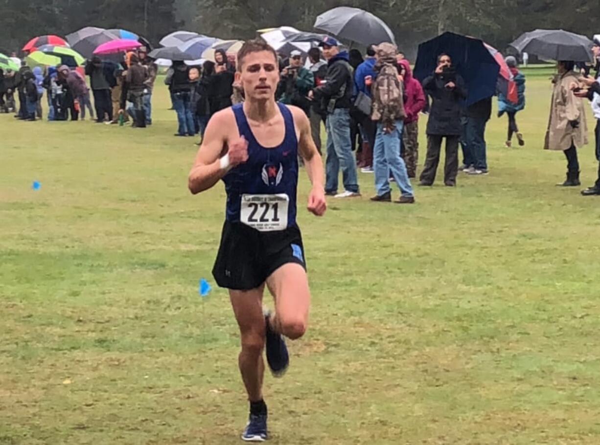 Kyle Radosevich of Ridgefield nears the finish line en route to his second district cross country title Thursday at Lewis River Golf Course.