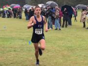 Kyle Radosevich of Ridgefield nears the finish line en route to his second district cross country title Thursday at Lewis River Golf Course.