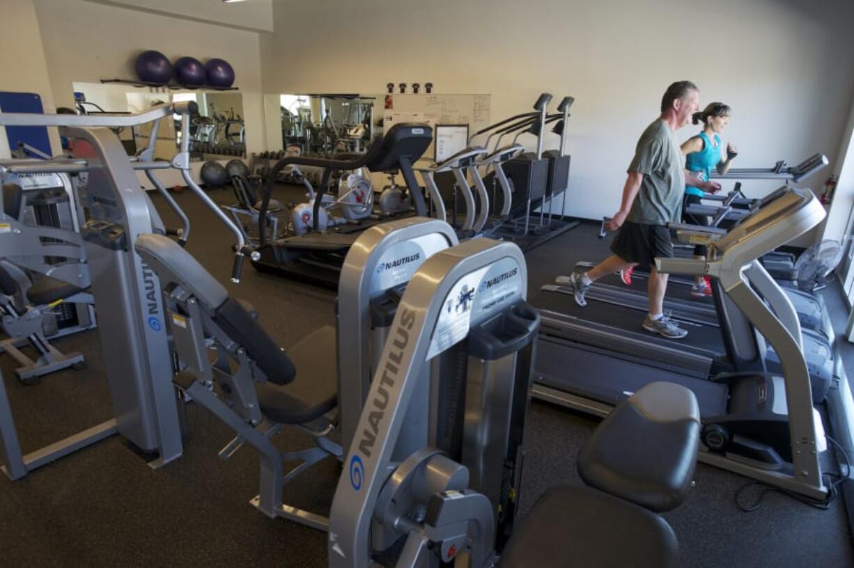 Employees use the company workout room during a tour of the Nautilus headquarters in Vancouver in May 2013.