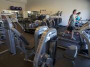 Employees use the company workout room during a tour of the Nautilus headquarters in Vancouver in May 2013.