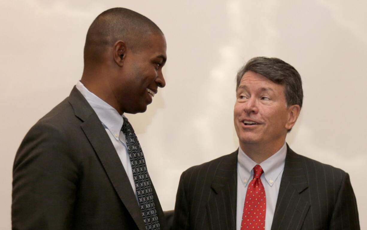 Republican U.S. Rep. John Faso, right, and his Democratic challenger, Antonio Delgado, talk after a candidate forum in Poughkeepsie, N.Y., on Wednesday. Hip-hop, health care and Brett Kavanaugh have emerged as issues in a too-close-to-call congressional race in New York’s Hudson Valley that pits the freshman Republican congressman against a rapper-turned-corporate lawyer seeking his first political office.