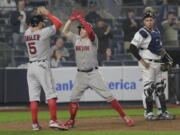 Boston Red Sox’s Brock Holt, center, celebrates with Ian Kinsler (5) after hitting a two-run home run against the New York Yankees during the ninth inning of Game 3 of baseball’s American League Division Series, Monday, Oct. 8, 2018, in New York. Holt hit for the cycle in the Red Sox’s 16-1 win.