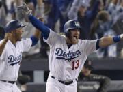 Los Angeles Dodgers' Max Muncy celebrates his walk off home run against the Boston Red Sox during the 18th inning in Game 3 of the World Series baseball game on Saturday, Oct. 27, 2018, in Los Angeles. (AP Photo/Mark J.