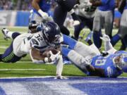 Seattle Seahawks running back Chris Carson (32) dives into the end zone for a 7-yard touchdown rush during the second half of an NFL football game against the Detroit Lions, Sunday, Oct. 28, 2018, in Detroit.