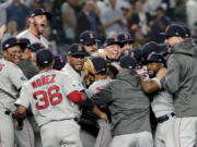 The Boston Red Sox celebrate after beating the New York Yankees 4-3 in Game 4 of baseball’s American League Division Series, Tuesday, Oct. 9, 2018, in New York.