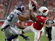 Arizona Cardinals wide receiver Chad Williams (10) makes the catch as Seattle Seahawks defensive back Earl Thomas (29) defends during the first half of an NFL football game, Sunday, Sept. 30, 2018, in Glendale, Ariz.