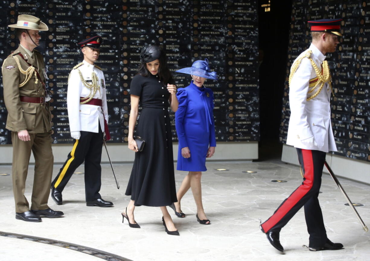 Britain’s Prince Harry, right, and his wife Meghan, center left, the Duchess of Sussex attend the opening of Anzac Memorial at Hyde Park in Sydney, Australia, Saturday, Oct. 20, 2018. Prince Harry and his wife Meghan, Duchess of Sussex, are on a 16-day tour to Australia and the South Pacific.