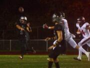 Union quarterback Lincoln Victor gets a pass off to receiver Alex Vallejo during a game against Camas at McKenzie Stadium in Vancouver on Friday, October 26, 2018. Union beat Camas 14-7.