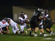 Camas running back Jacques Badolato-Birdsell finds a hole in the Union defense at McKenzie Stadium in Vancouver on Friday, October 26, 2018. Union beat Camas 14-7.