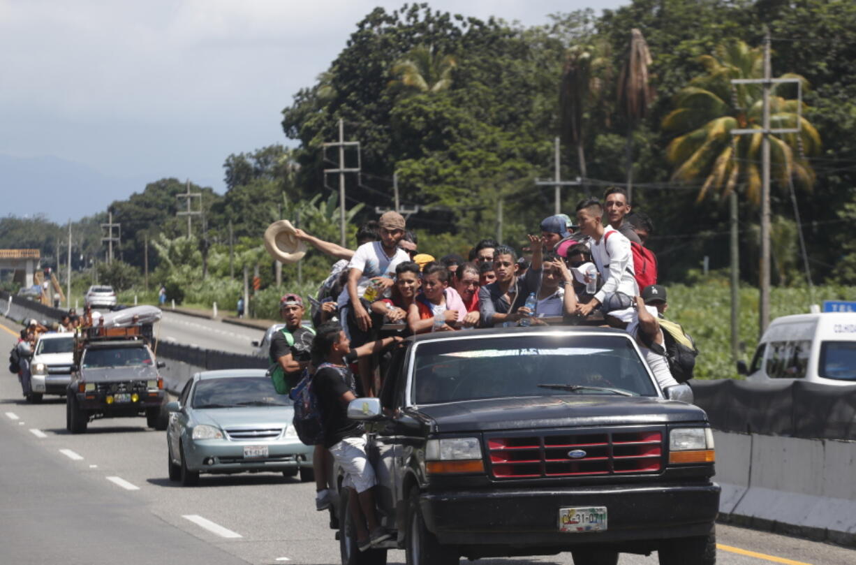 Central American migrants making their way to the U.S. in a large caravan fill the truck of a driver who offered them the free ride, as they arrive to Tapachula, Mexico, Sunday. Despite Mexican efforts to stop them at the Guatemala-Mexico border, about 5,000 Central American migrants resumed their advance toward the U.S. border Sunday in southern Mexico.