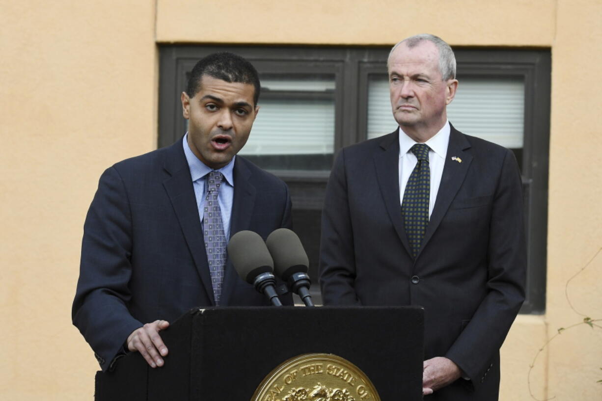 New Jersey Department of Health Commissioner Dr. Shereef Elnahal, left, speaks about the adenovirus outbreak as New Jersey Gov. Phil Murphy looks on during a press conference at the The Wanaque Center for Nursing and Rehabilitation on Wednesday, Oct. 24, 2018 in Wanaque, N.J. There have been 18 cases overall at the Wanaque Center for Nursing and Rehabilitation in Haskell, about 30 miles (50 kilometers) northwest of New York, officials said. The 227-bed, for-profit facility has a pediatric unit but also cares for elderly residents.