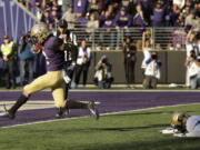 Washington wide receiver Aaron Fuller, left, scores a touchdown after evading Colorado cornerback Dante Wigleyk right, during the second half of an NCAA college football game, Saturday, Oct. 20, 2018, in Seattle. Washington won 27-13. (AP Photo/Ted S.