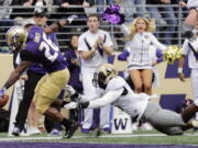 Washington running back Salvon Ahmed, left, scores a touchdown ahead of Colorado linebacker Davion Taylor during the first half of an NCAA college football game, Saturday, Oct. 20, 2018, in Seattle. (AP Photo/Ted S.