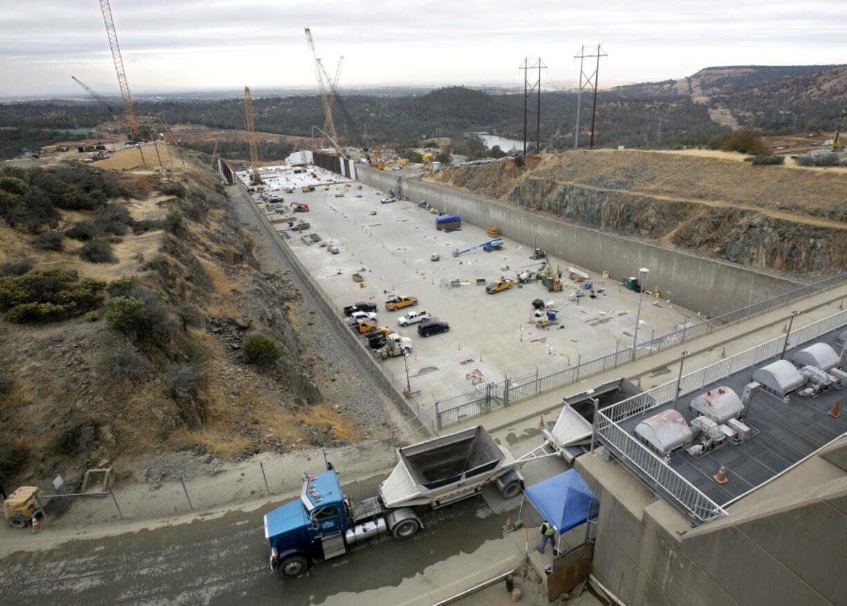 Crews work to repair the damaged main spillway of the Oroville Dam on Oct. 19, 2017, in Oroville, Calif. The Department of Water Resources announced Wednesday that it has met its Nov. 1 goal of completely reconstructing the dam’s main spillway in time for the upcoming winter.