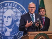 Gov. Jay Inslee addresses a news conference Thursday in Olympia with Attorney General Bob Ferguson following an earlier announcement that Washington’s Supreme Court struck down the state’s death penalty.