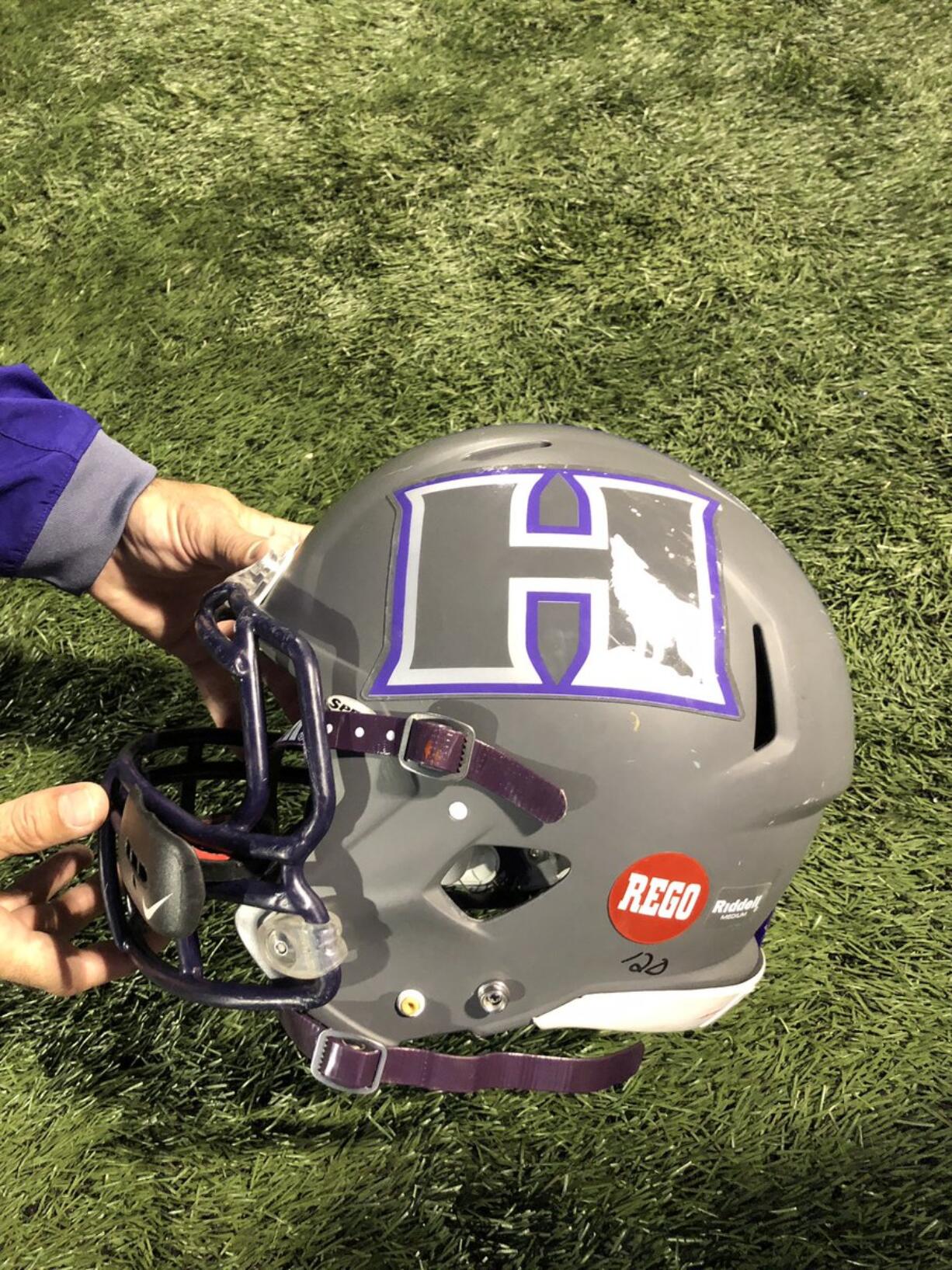 Heritage football players wore a red sticker that read "Rego" in its game against Union on Thursday at McKenzie Stadium to honor the life of recently deceased Titans assistant coach Mark Rego.