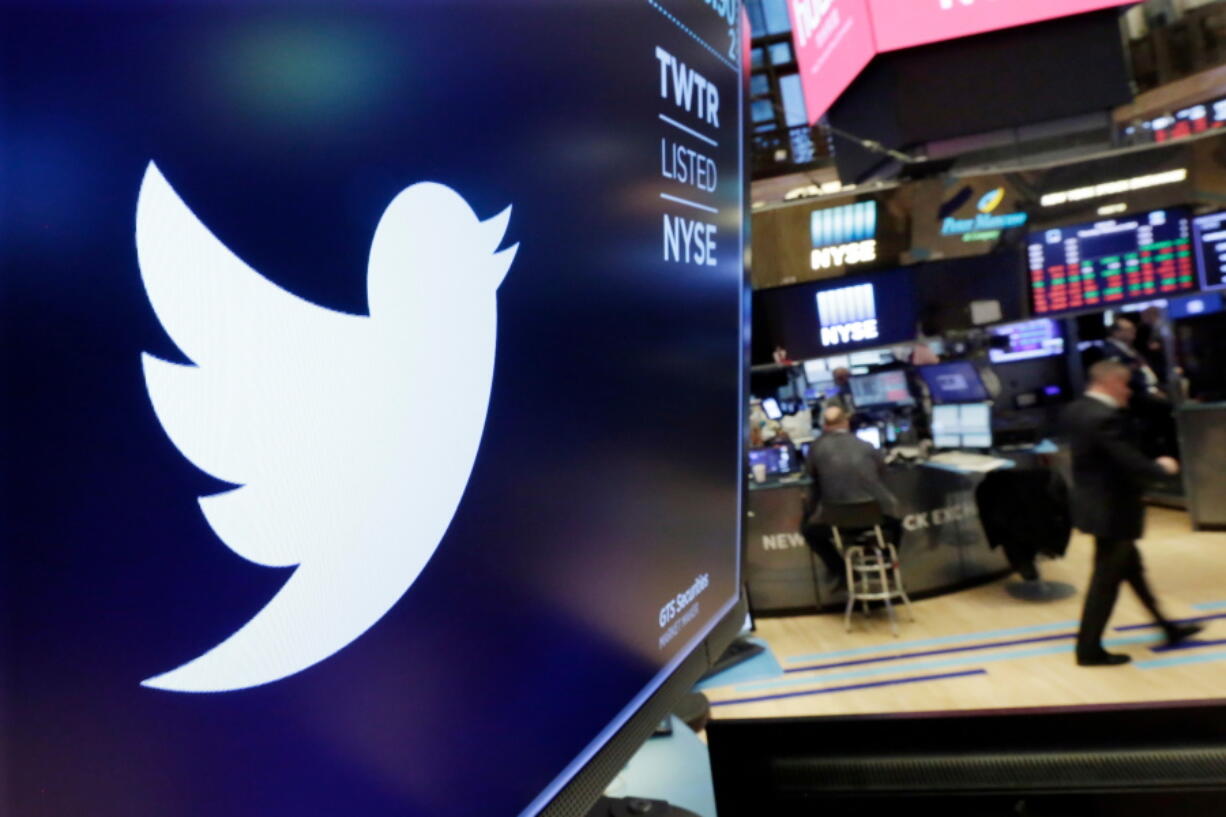 The logo for Twitter is displayed above a trading post on the floor of the New York Stock Exchange. Twitter reports earnings Thursday, Oct. 25.