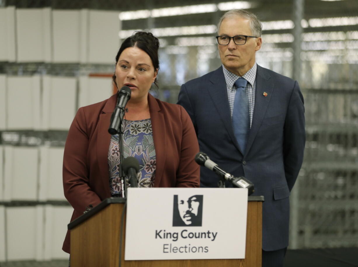 Washington Gov. Jay Inslee, right, looks on as King County Elections Director Julie Wise, left, talks to reporters about measures the state will take to insure secure voting in the upcoming November election, during a news conference Tuesday in Renton. (AP Photo/Ted S.