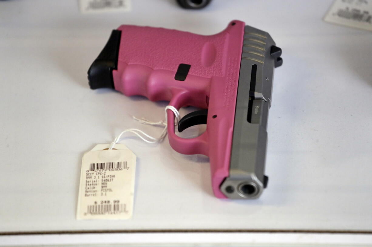 A pistol sits in a display case at a gun shop in Lynnwood. Washington’s Initiative 1639 would require safe storage of all firearms and tougher background checks for buyers of semi-automatic rifles.