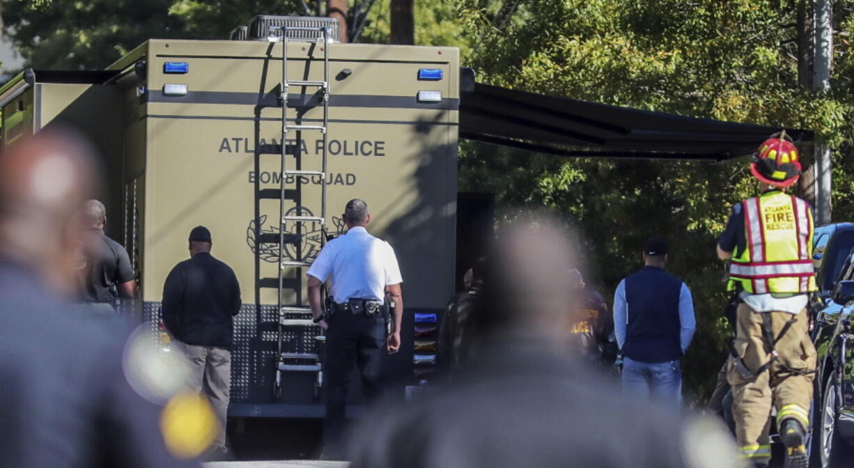 A bomb squad arrives with other authorities at a mail facility in Atlanta after reports that a suspicious package was found Monday.