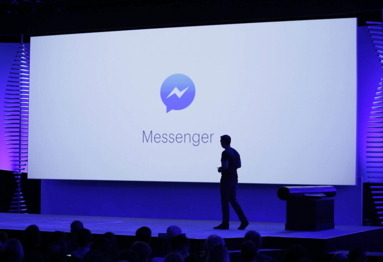 FILE - In this April 12, 2016 file photo, David Marcus, Facebook Vice President of Messaging Products, watches a display showing new features of Messenger during the keynote address at the F8 Facebook Developer Conference in San Francisco. On Tuesday, Facebook is announcing a redesign of its Messenger app with the stated goal of making it more simple to use.