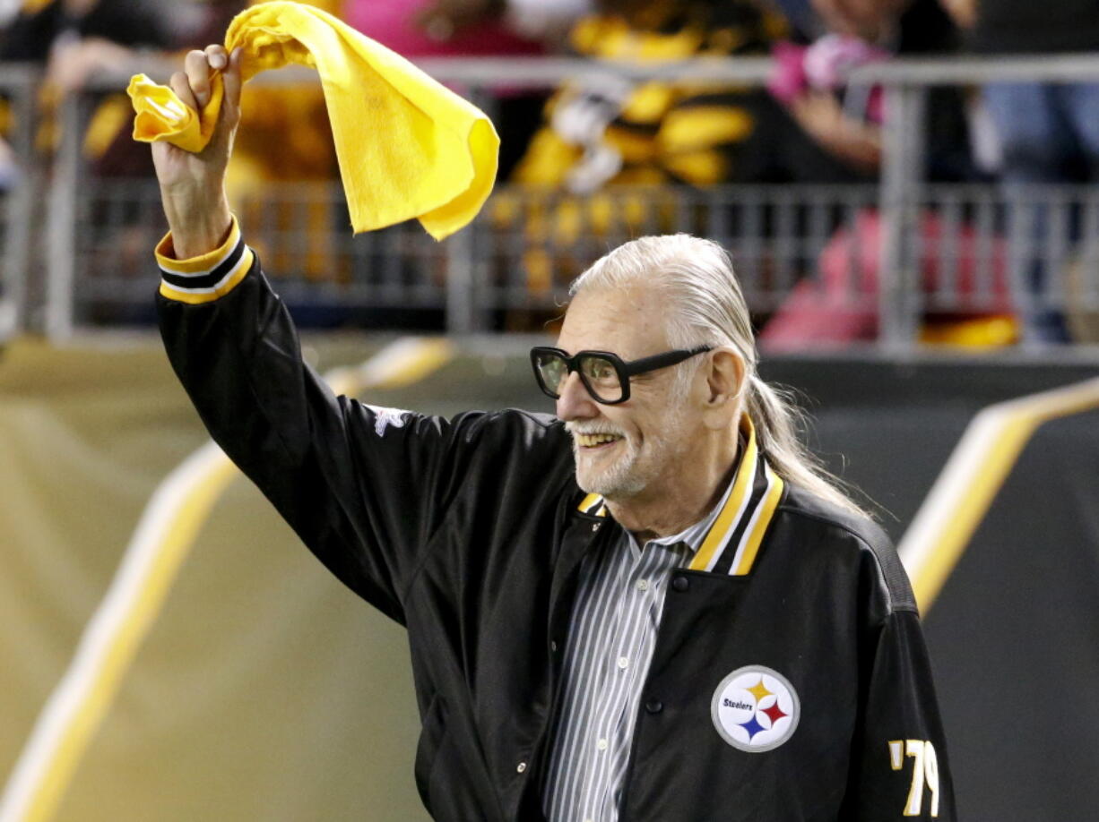 Horror film director George Romero, who directed “The Night of The Living Dead” waves a Terrible Towel before an NFL football game between the Pittsburgh Steelers and the Baltimore Ravens in Pittsburgh. Pittsburgh is set to honor the father of modern American zombie films outside the theater where his “Night of the Living Dead” premiered 50 years ago. The widow of Romero, Mayor Bill Peduto and others will gather at 10:30 p.m. Monday, Oct. 1, 2018. (AP Photo/Gene J.