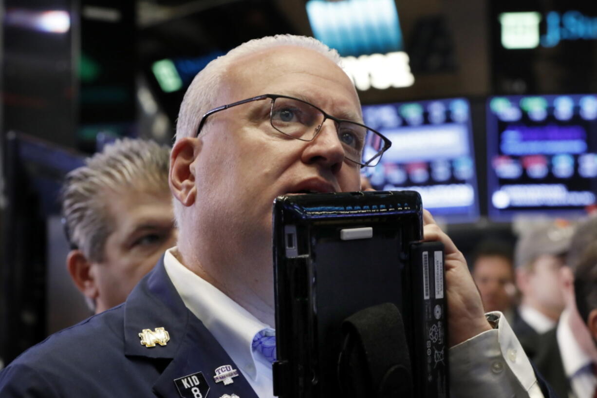 FILE- In this Oct. 11, 2018, file photo trader Thomas Ferrigno works on the floor of the New York Stock Exchange. The U.S. stock market opens at 9:30 a.m. EDT on Tuesday, Oct. 16.