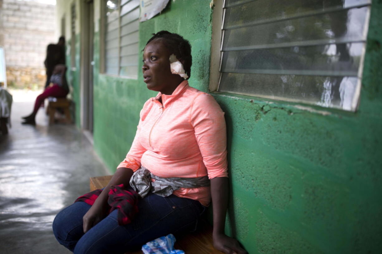 Shelda Similien, who ran out of her before it collapsed when a magnitude 5.9 earthquake hit the night before, waits to be treated at a local hospital in Gros Morne, Haiti, Sunday, Oct. 7, 2018. Similien's five year-old son died when he became buried by the rubble of the collapsed home.