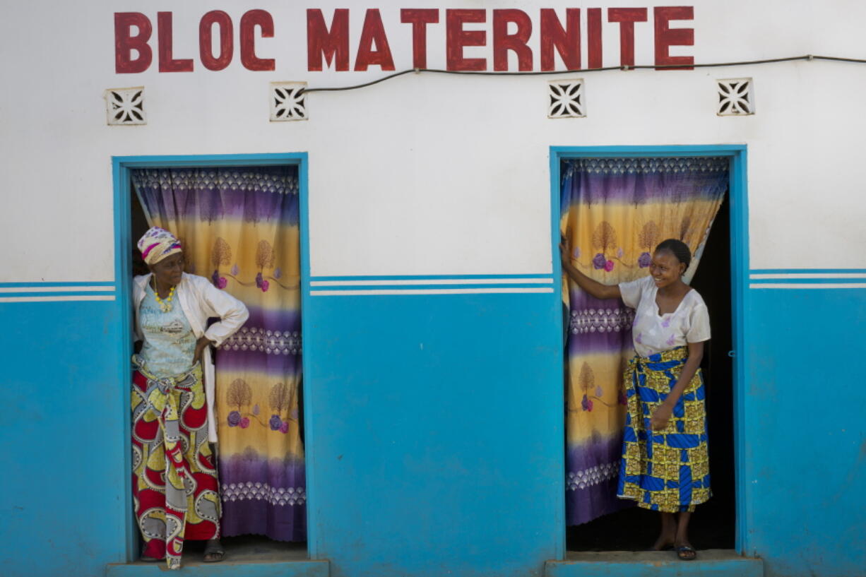 Alice Kabuya, 20, right, looks at a clinic employee at the Masaidizi Health Center in Lubumbashi, Democratic Republic of the Congo on Aug. 14, 2018. Kabuya gave birth to her daughter at the facility but is unable to pay the $150 medical bill. She said the clinic’s doors were locked every afternoon and that she could not walk more than about 10 feet outside before being reprimanded by nurses.