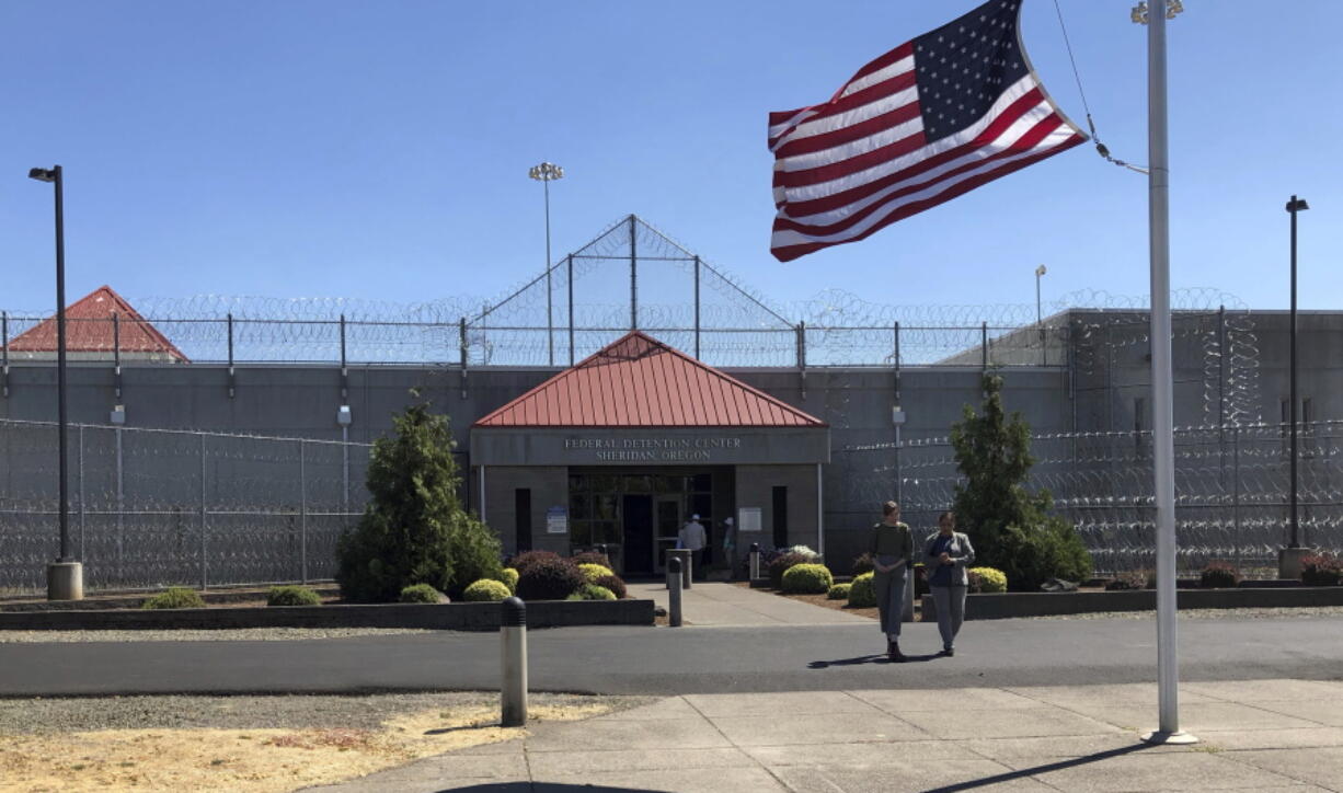 In this Wednesday, Aug. 29, 2018 photo, volunteers wait outside the federal prison in Sheridan, Ore., for a few asylum seekers to be released from custody, months after they and more than 100 other immigrants were brought to the prison.