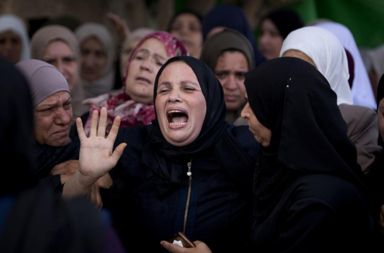 Relatives of Aisha Rabi, 48, mourn during her funeral Saturday in the West Bank village of Bidya. Rabi was struck in the head by a stone thrown by Israeli settlers, Palestinians said.