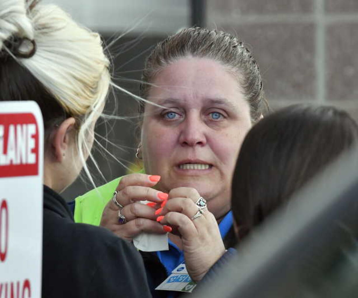 A Kroger employee wipes away tears following a shooting that left two people dead, and the subject in custody, Wednesday, Oct. 24, 2018, in Jeffersontown, Ky. (AP Photo/Timothy D.