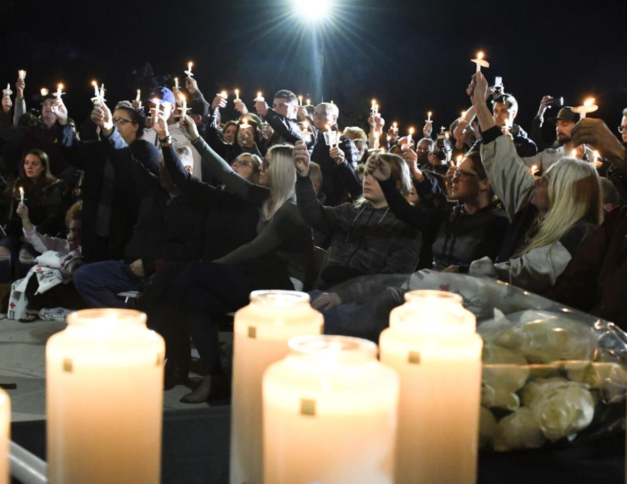 Family members and friends gather for a candlelight vigil memorial at Mohawk Valley Gateway Overlook Pedestrian Bridge in Amsterdam, N.Y., on Monday.