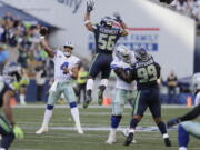 FILE - In this Sept. 23, 2018, file photo, Seattle Seahawks linebacker Mychal Kendricks (56) leaps as Dallas Cowboys quarterback Dak Prescott (4) attempts a pass during the second half of an NFL football game in Seattle. The Cowboys, who can’t find anything remotely resembling a rhythm with quarterback Dak Prescott and a new group of receivers, are at home this week against the Detroit Lions.