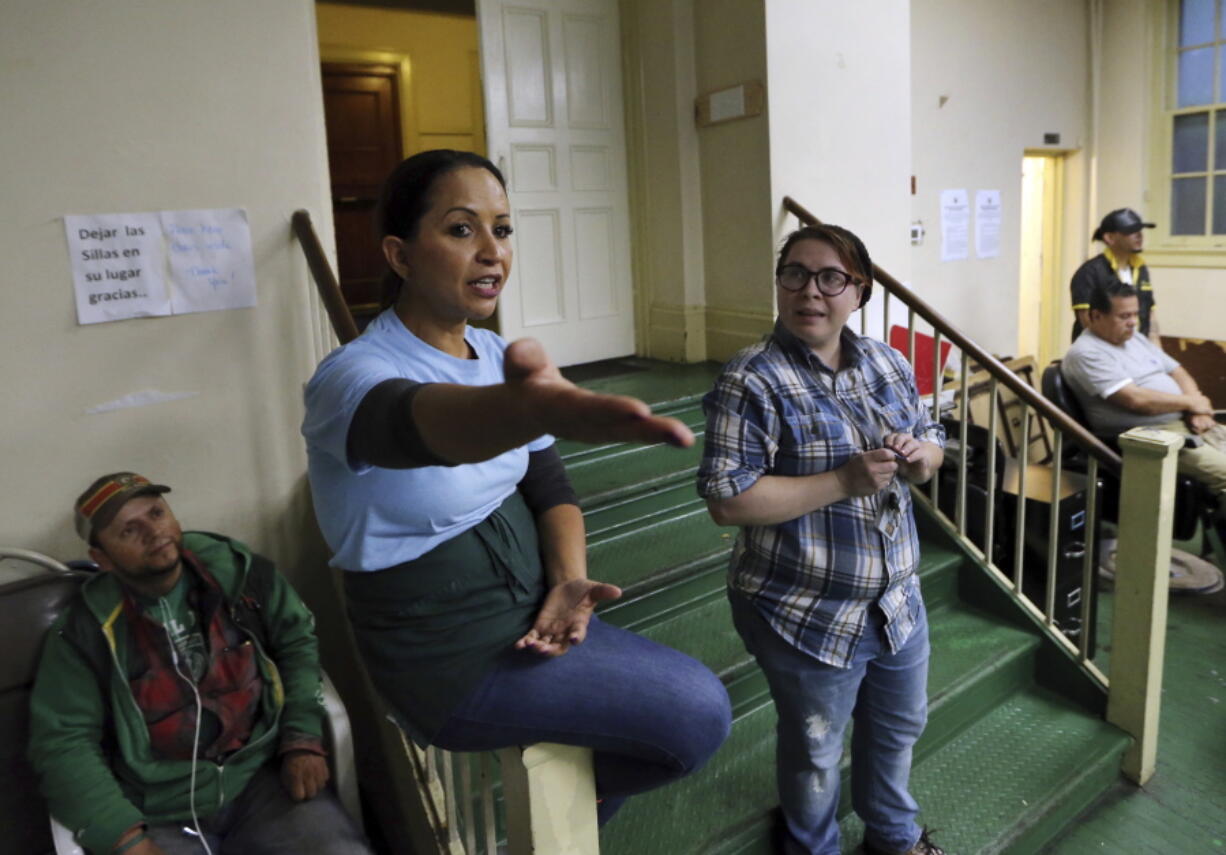 Community peace walk organizer, Sandra Aleman-Nijjar, speaks to people at a soup kitchen that she runs in East Boston. Nearly three years after the nation’s largest single takedown of MS-13 gang members, residents in the strongly Central American communities around Boston say the streets are noticeably quieter.