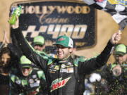 Chase Elliott celebrates winning a NASCAR Cup Series auto race at Kansas Speedway in Kansas City, Kan., Sunday, Oct 21, 2018. (AP Photo/Colin E.