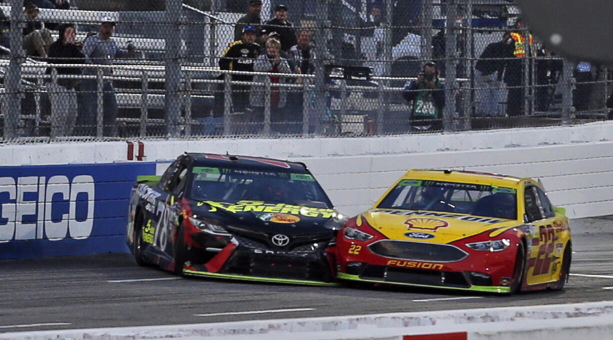 Joey Logano (22) and Martin Truex Jr. (78) make contact as they approach the finish line at the Monster Energy NASCAR Cup Series auto race at Martinsville Speedway in Martinsville, Va., Sunday, Oct. 28, 2018. Logano won the race.