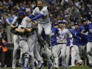 The Los Angeles Dodgers celebrate after Game 7 of the National League Championship Series baseball game Saturday, Oct. 20, 2018, in Milwaukee. The Dodgers won 5-1 to win the series.