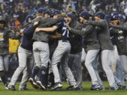 Milwaukee Brewers celebrate after the final out by the Colorado Rockies in the ninth inning of Game 3 of a baseball National League Division Series Sunday, Oct. 7, 2018, in Denver. The Brewers won 6-0 to sweep the series in three games and move on to the National League Championship Series.