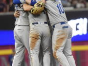 Los Angeles Dodgers team members embrace after Game 4 of baseball’s National League Division Series against the Atlanta Braves, Monday, Oct. 8, 2018, in Atlanta. The Los Angeles Dodgers won 6-2.