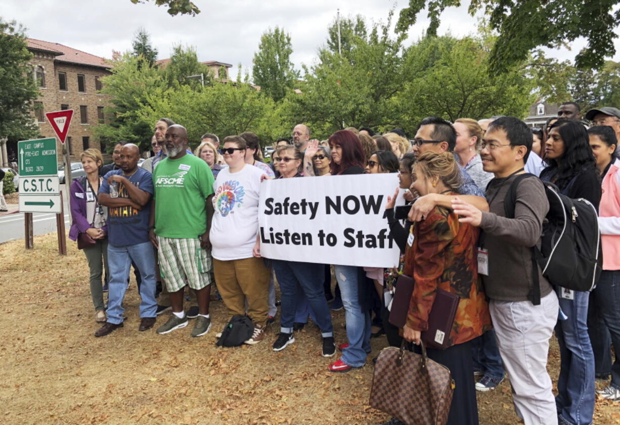 Workers rally demanding changes to the way officials assign dangerous patients to wards at Western State Hospital in Lakewood, Wash. A patient at Washington state’s largest psychiatric hospital vaulted over the nurse’s station, knocked a nurse to the floor, choked her and bit part of her ear off. The Sunday, Sept 30, 2018, assault is the latest in a series of attacks on health care workers at Western State Hospital.