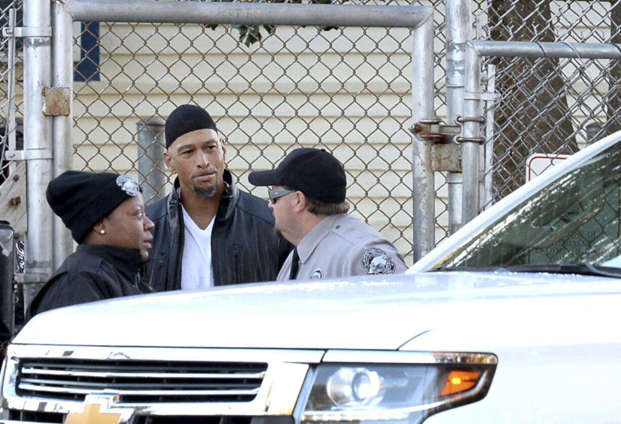 Former Carolina Panthers NFL football player Rae Carruth, center, exits the Sampson Correctional Institution in Clinton, N.C., on Monday. Former NFL wide receiver Rae Carruth has been released from prison after serving 18 years for conspiring to murder the mother of his unborn child. The Carolina Panthers’ 1997 first-round draft pick was released Monday from Sampson Correctional Institution in Clinton, North Carolina after completing his sentence.