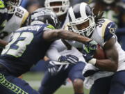 Los Angeles Rams running back Todd Gurley, right, powers past Seattle Seahawks free safety Tedric Thompson (33) to score a touchdown during the second half of an NFL football game, Sunday, Oct. 7, 2018, in Seattle.