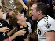 New Orleans Saints quarterback Drew Brees (9) greets his family after he broke the NFL all-time passing yards record in the first half of an NFL football game against the Washington Redskins in New Orleans, Monday, Oct. 8, 2018.